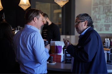 Attendees networking at Goliath Coffee Roaster's business networking event