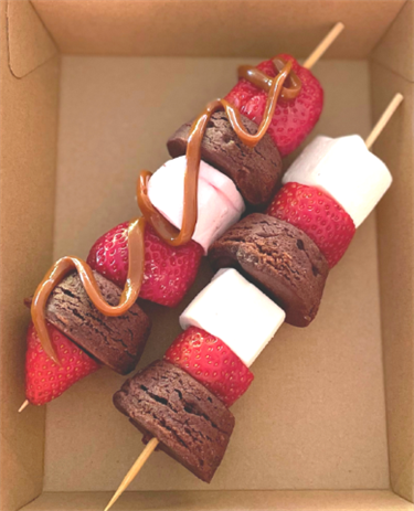 Strawberry, brownie bites and marshmallows kabob with Dolce de luce drizzled