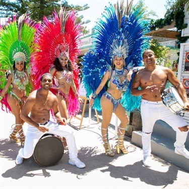 Brazilian men and women in colourful samba dance attire