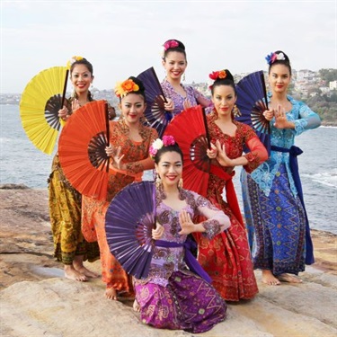 Women posing for a photo in Indonesian dance tire with fans