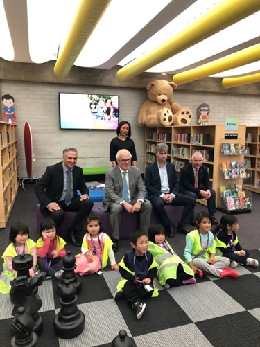 Mayor Frank Carbone, State Librarian John Vallance, Councillor Dai Le and City Manager Alan Young smiling and posing with young children wearing high visibility vests