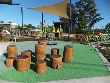 Decorative logs, merry-go-round and playground set