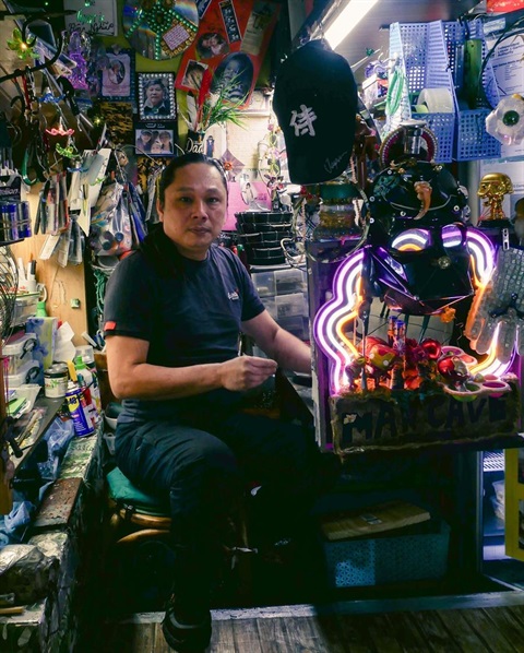 Artist Ben Nguyen portrait with many crafts around.