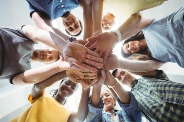 Circle of people laying hands