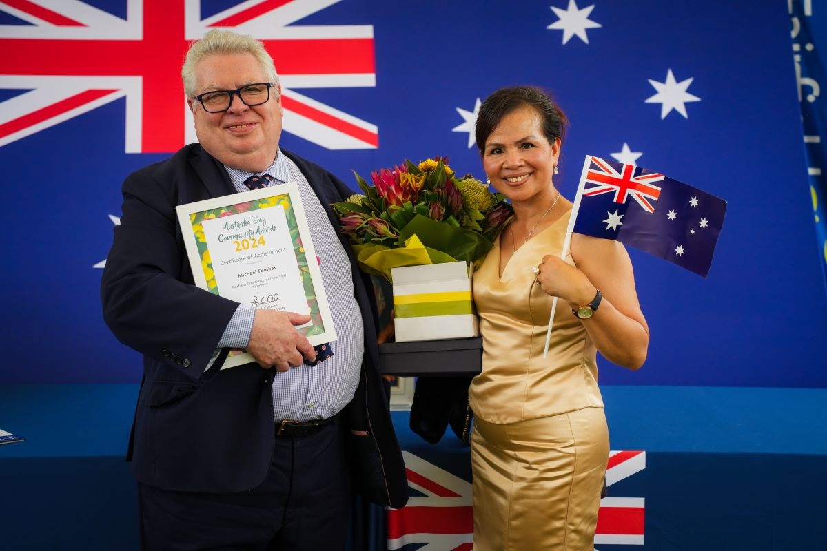 2 persons holding up Australia Day awards