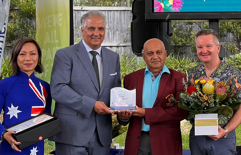 Portrait of Roylston holding Australia award with the mayor, MP Dai Le and MP Chris Bowen.