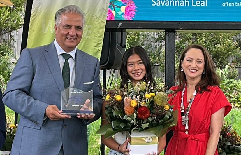 Portrait of Savannah Leal holding Australia Day award with the Mayor.