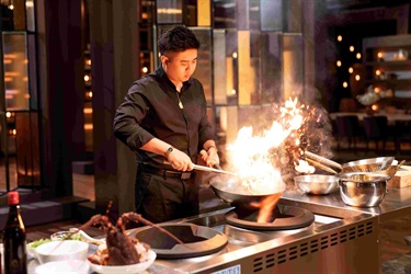 Vincent Lim cooking with a wok