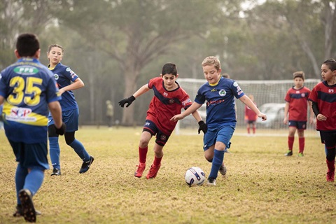 Adolescents playing soccer.