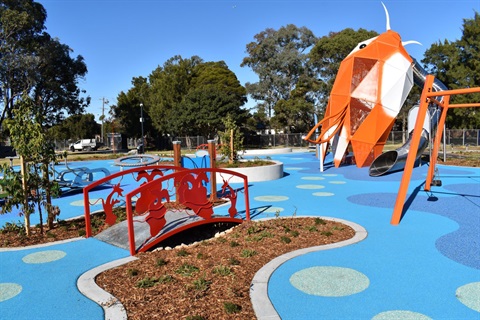 view of Bareena park with metal tube slide and small bridge