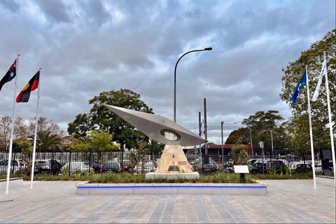 Monument flanked by flags at The Crescent