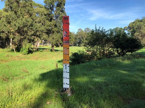 Flood marker set on Fairfield Golf Course Detention Basin