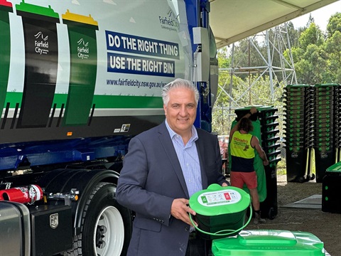 Mayor Frank Carbone holding the green bin