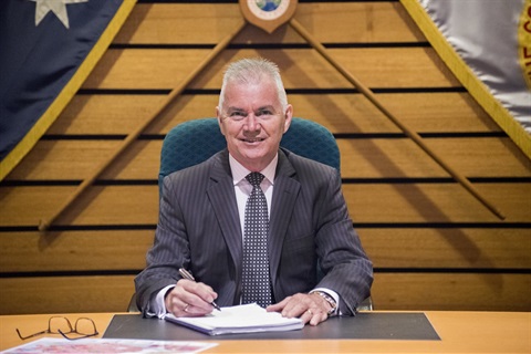 City Manager Alan Young smiling and posing while sitting in the Fairfield City Council Chambers 