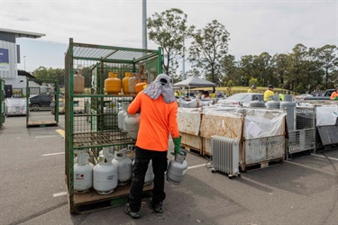 A staff is moving a trolley of domestic gas tank at the event.