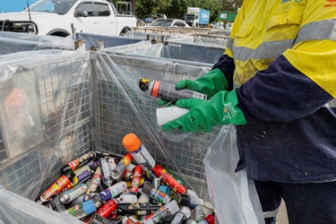 A staff sorting chemical waste.