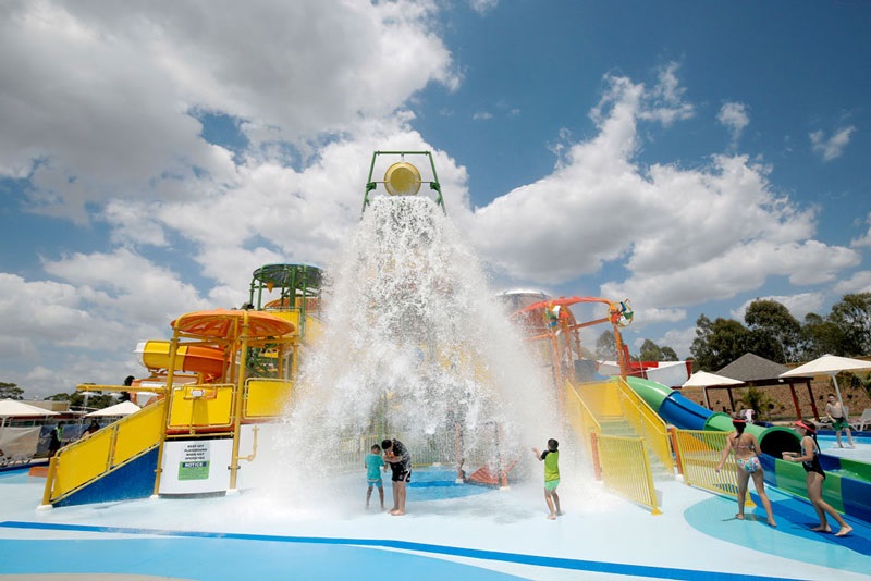 Tipping bucket pouring water over young children at Aquatopia Water Park at Prairiewood Leisure Centre 