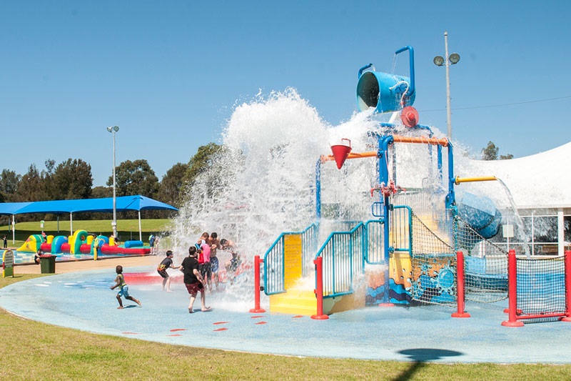 Fairfield Leisure Centre's Aquaplay giant tip bucket splashing water on a group of children