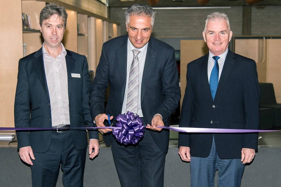 Mayor Carbone cuts the ribbon watched on by State Library of New South Wales Acting Executive Director Cameron Morley and FCC City Manager Alan Young