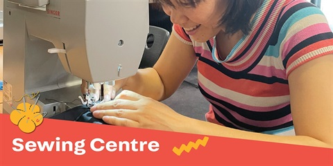 A smiling lady is sewing using the sewing machine.