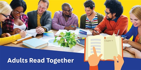 A group of adults sit on the same big table and read together.