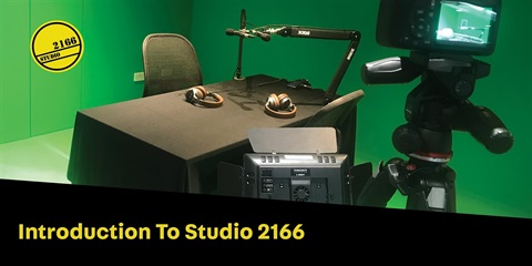 A studio room with a DSLR camera on a tripod and some other studio equipment's.